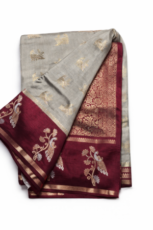 Elegant grey banarasi soft silk saree highlighted with gold motifs, a rich maroon zari border, and a beautifully detailed floral pallu.