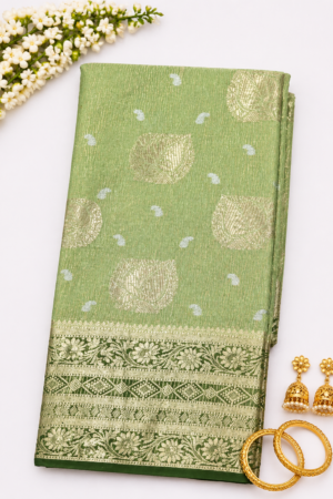 Pastel green Banaras tissue saree with gold zari butta motifs and rich dark green floral woven border