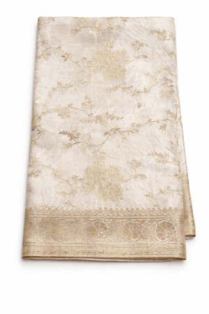 Luxurious ivory Banarasi silk saree adorned with intricate gold zari weaving, a regal border, and a striking contrast red blouse piece for timeless festive elegance.