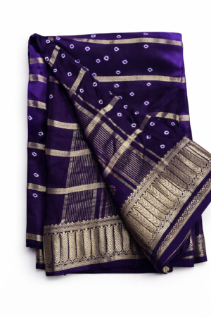 Elegant royal purple Bandhani saree featuring classic dotted motifs and rich gold zari woven borders for a timeless festive statement.