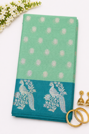 Mint green Banaras Kota saree with teal blue floral woven border and delicate butta motifs