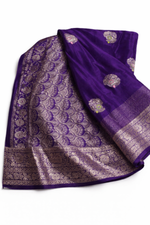 Elegant royal purple Chinon silk saree featuring delicate floral motifs and a rich woven floral border for a graceful festive look.