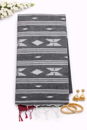 Elegant cotton Jamdani saree featuring crisp white geometric woven motifs, fine stripe detailing, and a timeless handloom-inspired ethnic appeal.