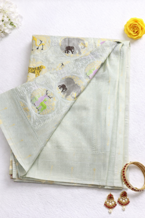 Graceful off white semi Gadwal saree featuring delicate woven motifs and a soft elegant finish for timeless festive charm.