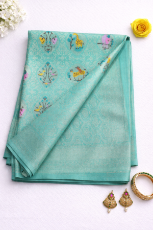 Refreshing aqua blue semi Gadwal saree adorned with delicate floral butis and a graceful traditional woven finish.