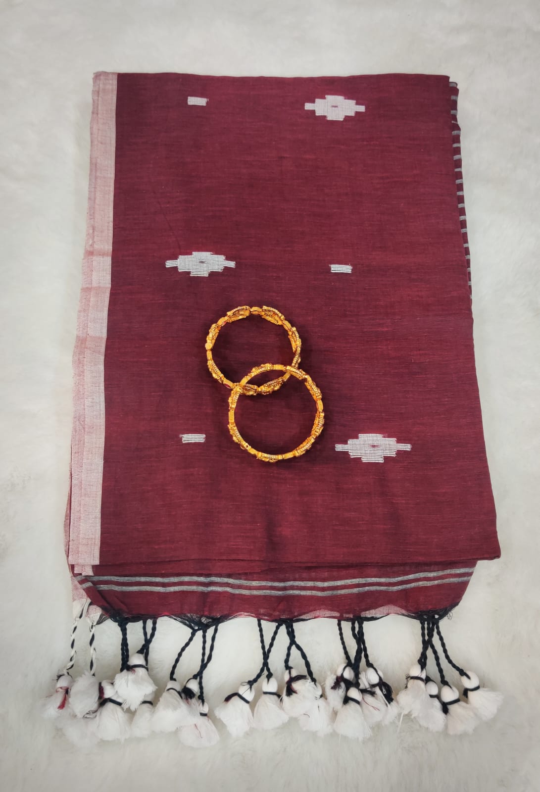 Elegant Maroon Linen Saree with White Woven Motifs, Contrast Border and Tassel Finish