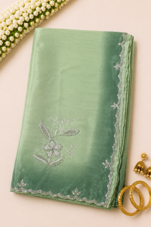 mint green maggam work saree with delicate embroidered motifs and elegant embellished border
