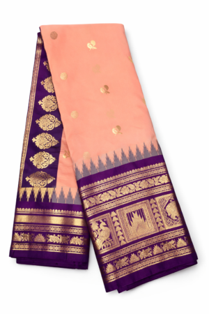 Graceful peach semi Gadwal saree featuring gold zari butis, a royal blue contrast border, and an elegant traditional woven pallu.