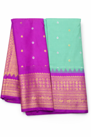 Vibrant mint green semi Gadwal saree paired with a rich magenta pallu and ornate zari border for a bold festive statement.
