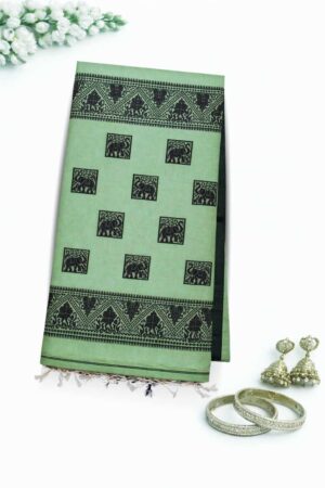 Elegant pista green cotton Jamdani saree featuring striking black elephant motifs, heritage-inspired woven borders, and a graceful handloom ethnic appeal.