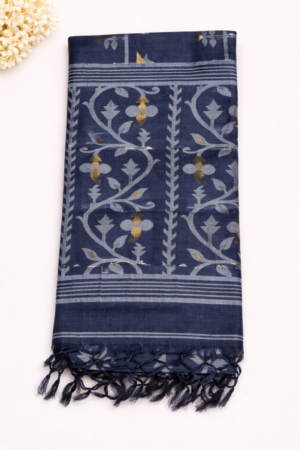 Elegant navy blue pure tussar saree featuring artistic floral Jamdani-style weaving, subtle zari accents, and handcrafted tassels for a refined ethnic look.