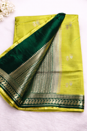 Graceful lime green raw mango silk saree with delicate zari butis and a rich emerald green contrast pallu & woven zari border for timeless elegance.