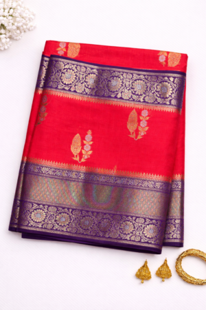 orange purple raw mango silk saree featuring elegant zari butis and a rich royal blue floral zari border for a regal festive statement.