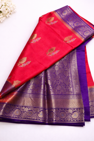 orange purple raw mango silk saree featuring elegant zari butis and a rich royal blue floral zari border for a regal festive statement.