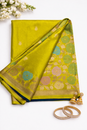 Radiant olive green Russian silk saree featuring elegant woven butis, a vibrant floral designer pallu, and a rich zari border for festive sophistication.