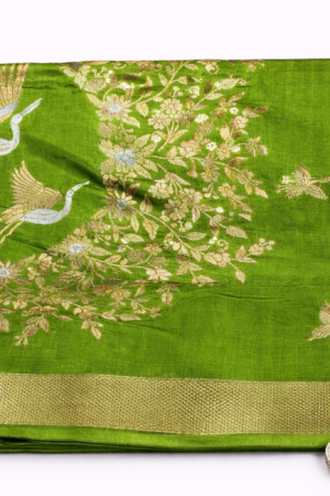 Graceful parrot green Russian silk saree featuring elegant floral vine weaving, artistic bird motifs, and a rich zari border for a luxurious festive look.