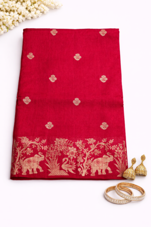 Elegant redRussian silk saree featuring delicate silver buti motifs and a richly woven floral pallu for a graceful festive statement.