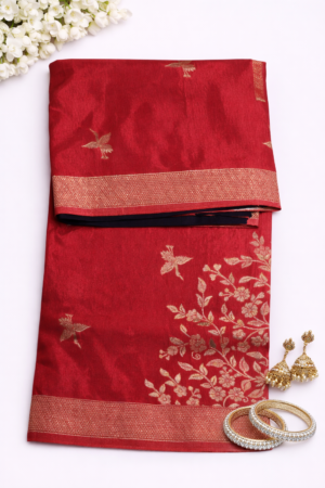 Elegant crimson red Russian silk saree featuring delicate bird motifs, a graceful floral woven panel, and a rich zari border for timeless festive charm.