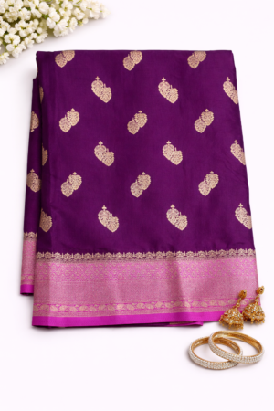 Elegant royal purple Russian silk saree featuring silver buti motifs, a rich contrast pink woven pallu, and a graceful festive finish.