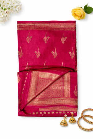 Vibrant rani pink soft silk saree featuring elegant gold bird motifs, delicate buti detailing, and a rich woven zari border for a graceful festive statement.