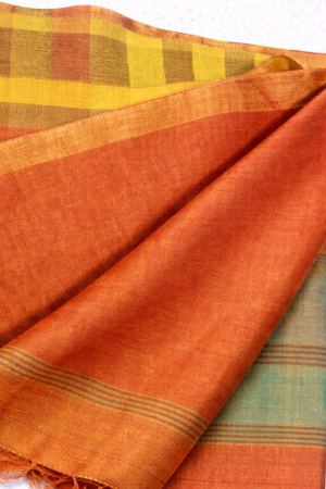 Elegant striped saree with warm hues, subtle sheen, and a beautifully finished tassel pallu.