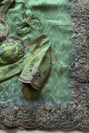 Mint green designer saree with heavy embroidered scalloped border and blouse